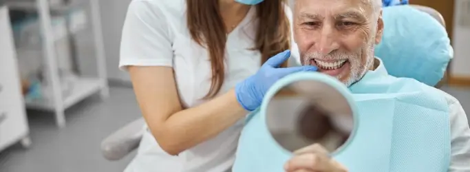 patient looking at completed dental implants